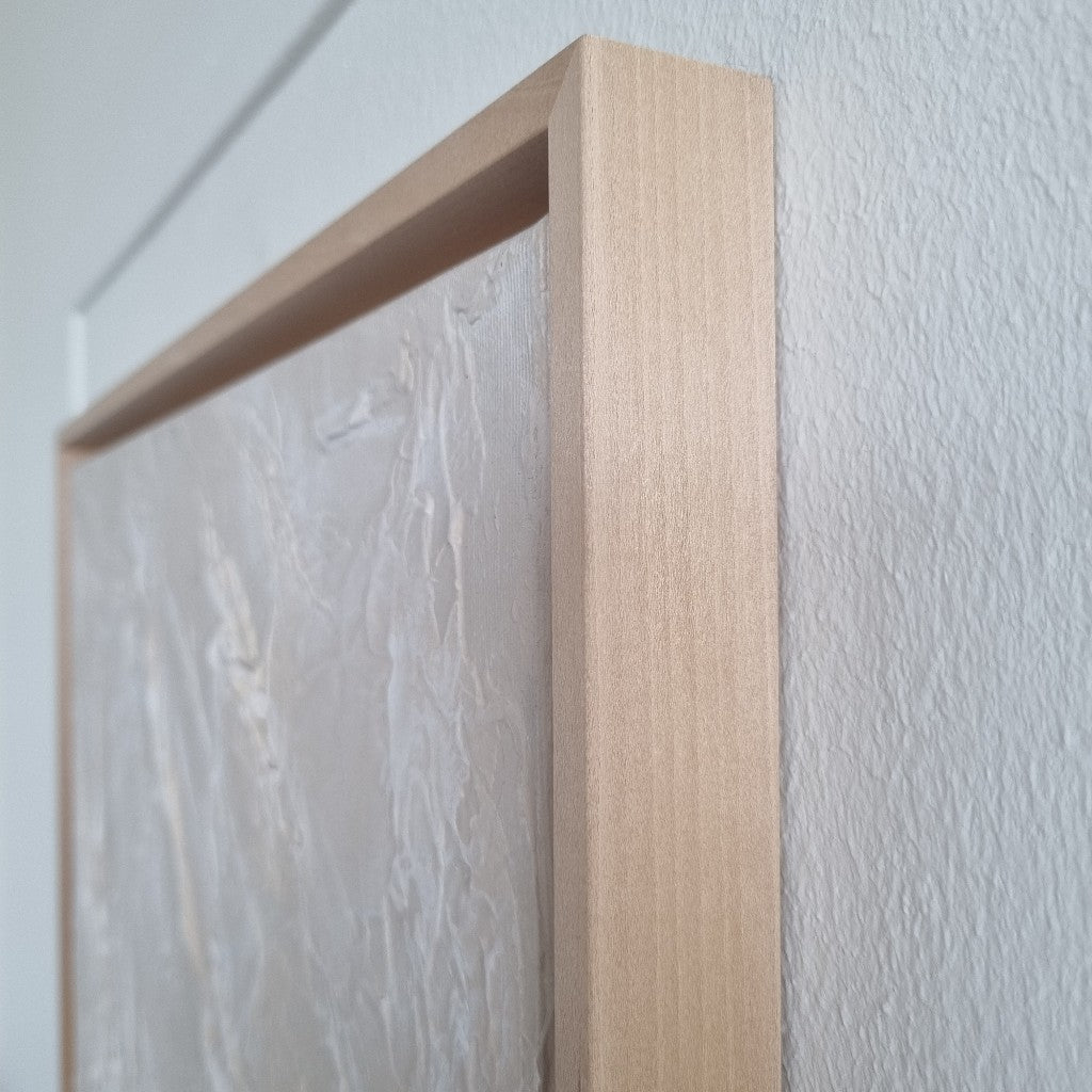 Light beige monochromic textured painting with wooden floating frames.