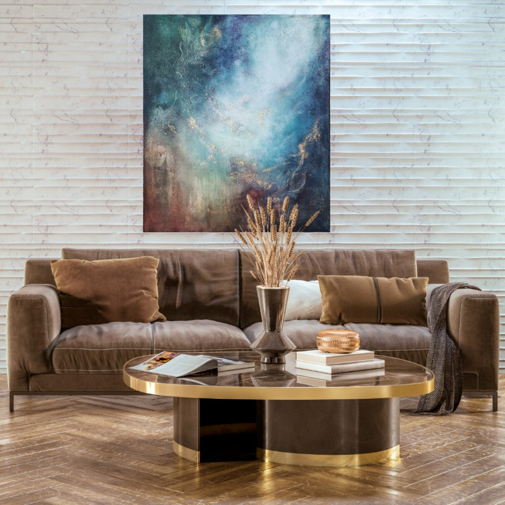 Large colorful artwork in the luxury living room with shades of brown and gold.