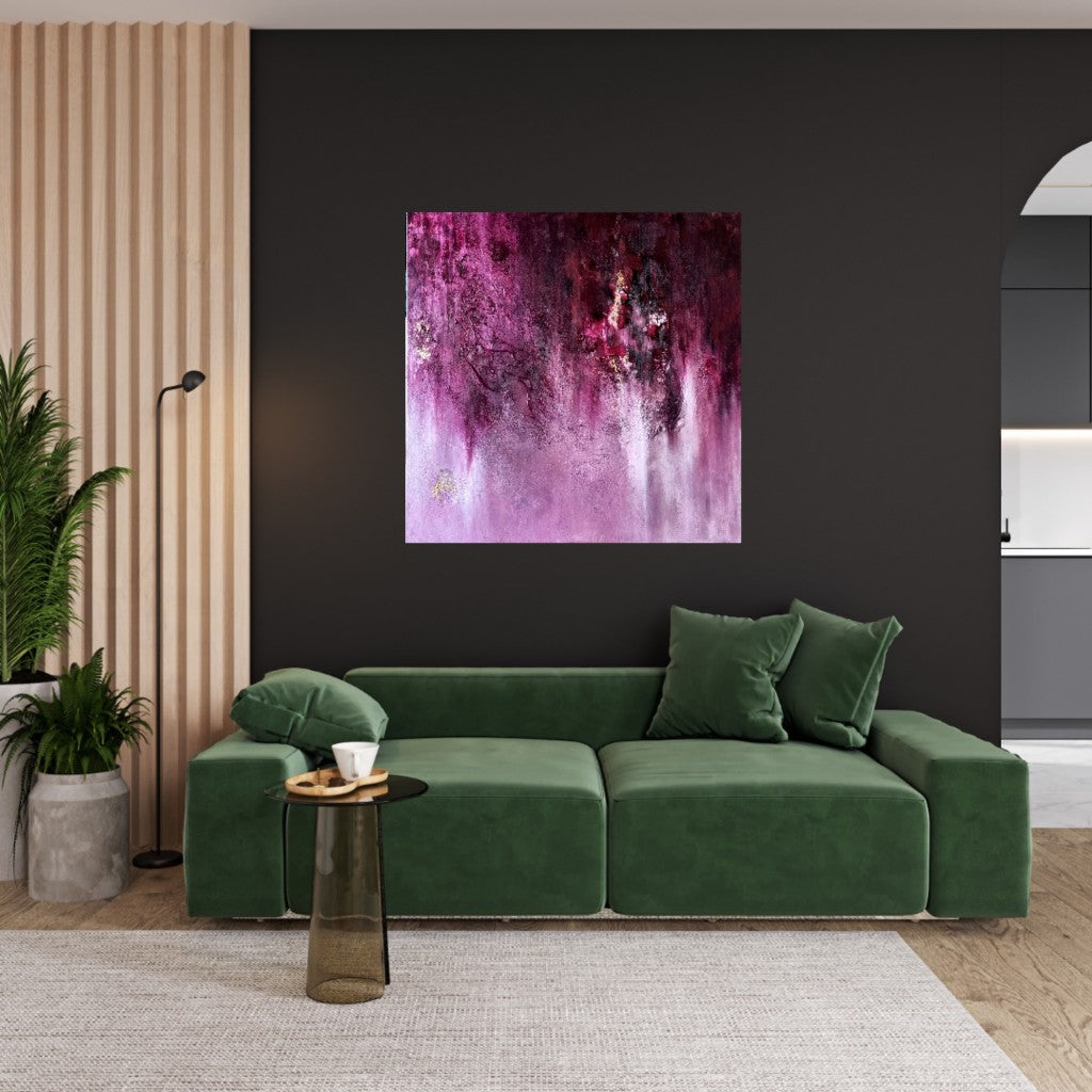 Pink abstract artwork paired with a green sofa in a fresh, contemporary living space.