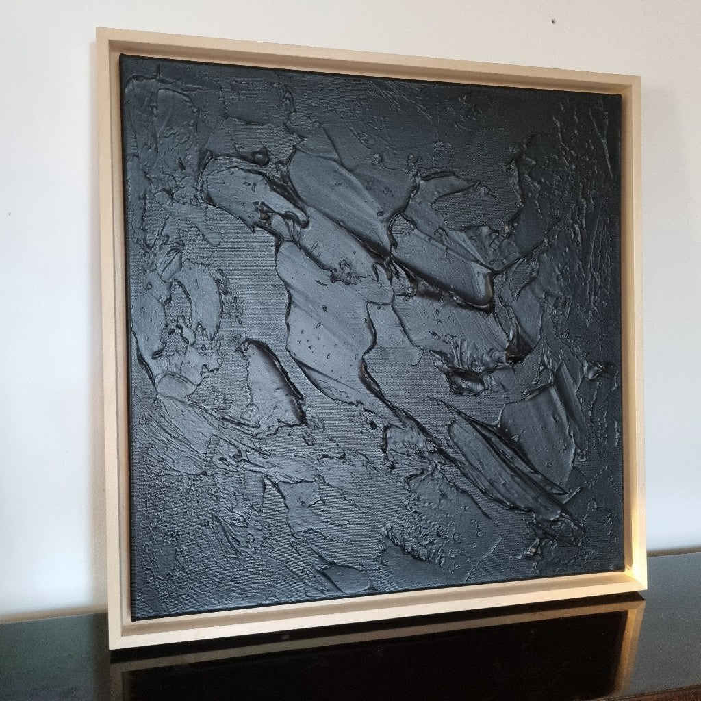 Black monochrome textured painting framed with wooden floating frames.