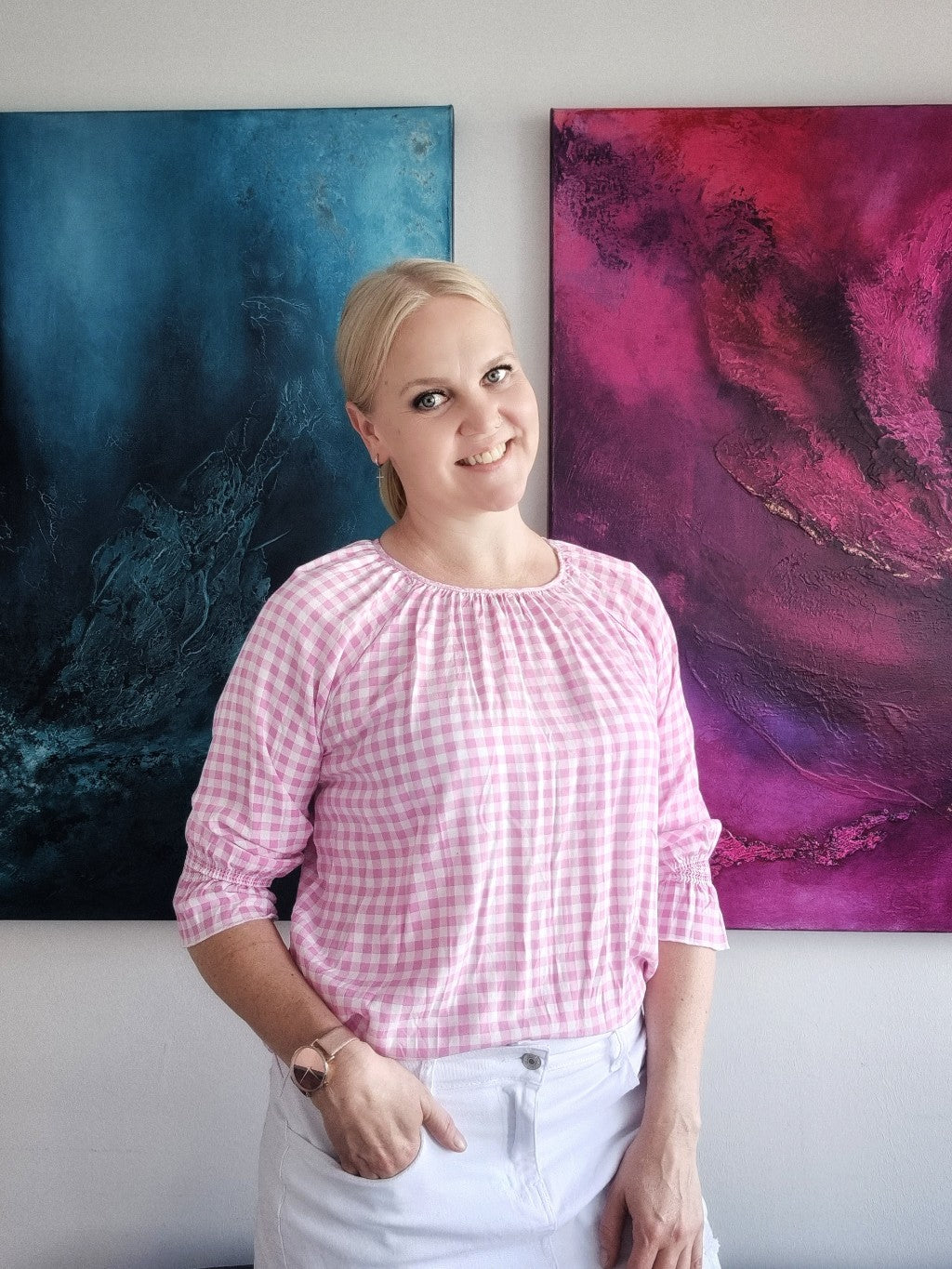 Female artist smiling in the studio.