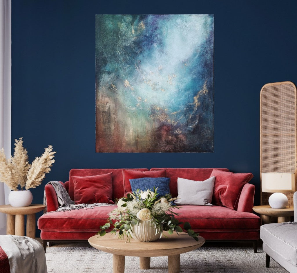 The sizeable colorful artwork on a dark blue wall. A wooden coffee table and a red sofa complete the stylish interior decor. 