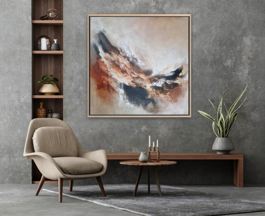 Large abstract acrylic painting with warm autumn colors. In a modern style living room on the gray wall with wooden furnitures.